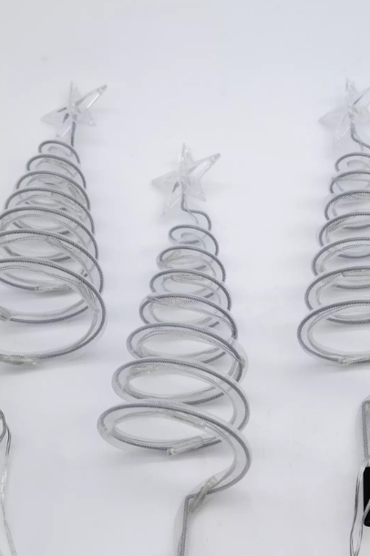 Metallic spiral Christmas tree decorations on a white background