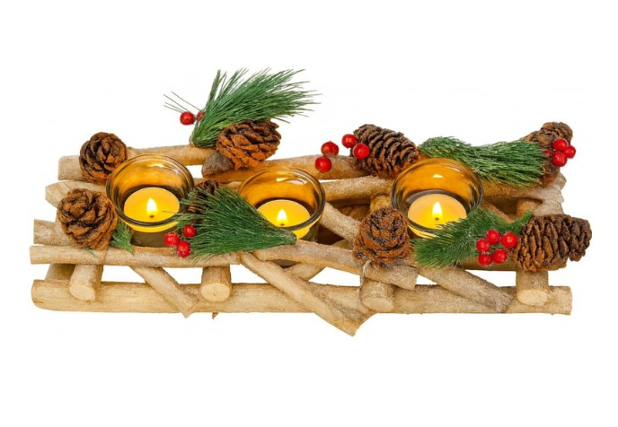Decorative arrangement with candles, pine cones, and greenery on a wooden surface.