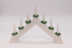 Decorative arch with candles and greenery on a white background