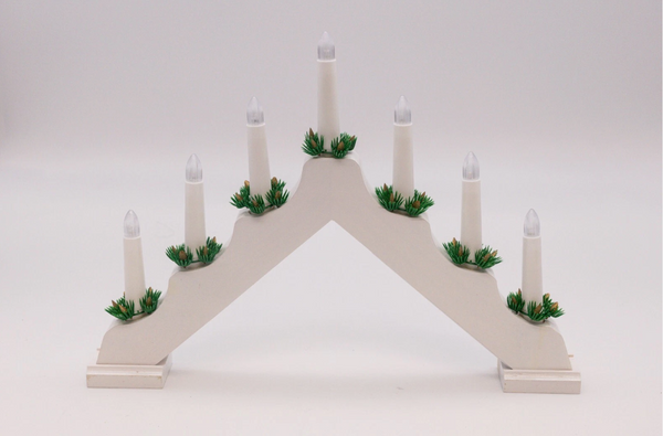 Decorative arch with candles and greenery on a white background
