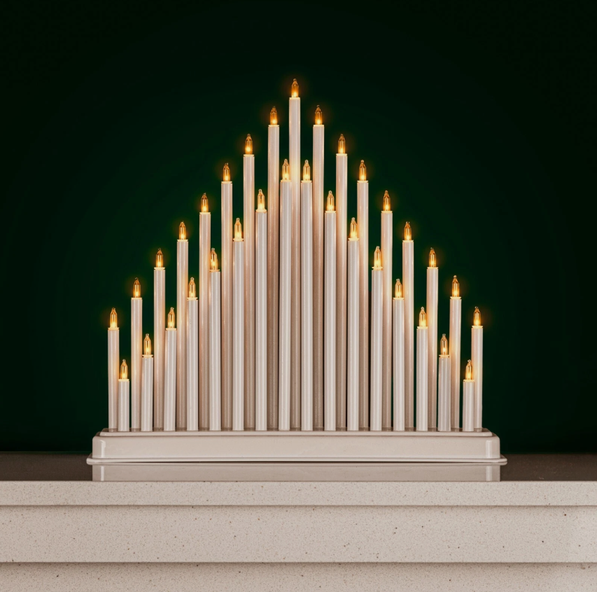 Decorative candle arrangement on a dark green background