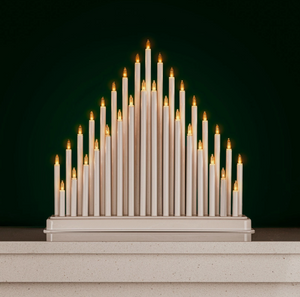 Decorative candle arrangement on a dark green background