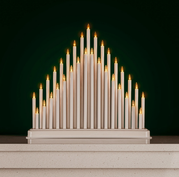 Decorative candle arrangement on a dark green background