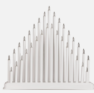 White candle holder with multiple candles on a white background