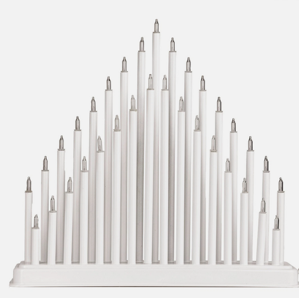 White candle holder with multiple candles on a white background