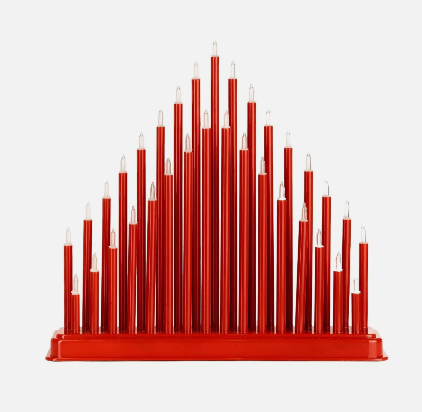 Red candle-like sculpture with gold accents on a dark background