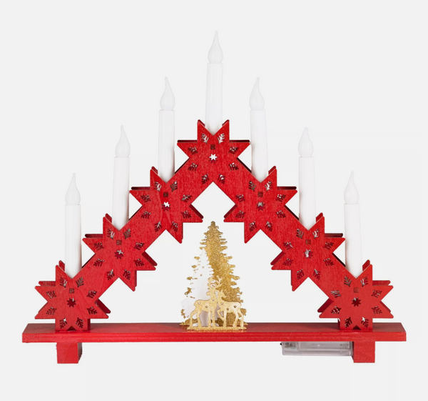 Decorative red arch with white candles and a gold tree on a white background