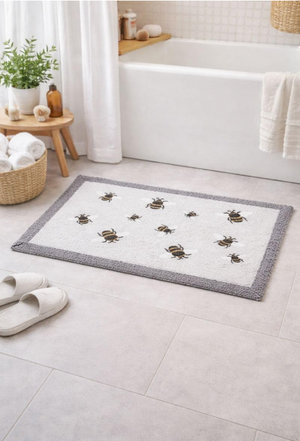Bath mat with beetle design on a bathroom floor