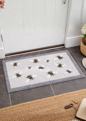 Doormat with bee design on a tiled floor