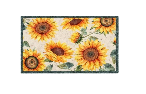 Decorative doormat with sunflower pattern on a wooden floor.