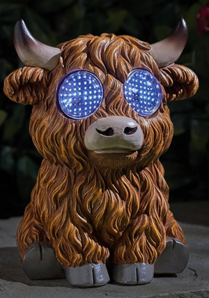 Statue of a bull with glowing blue eyes on a dark background