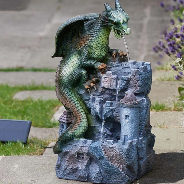 Dragon fountain sculpture on a stone base with water feature, outdoors.