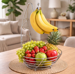 Fruit basket with bananas, grapes, strawberries, and a pineapple on a table in a living room.