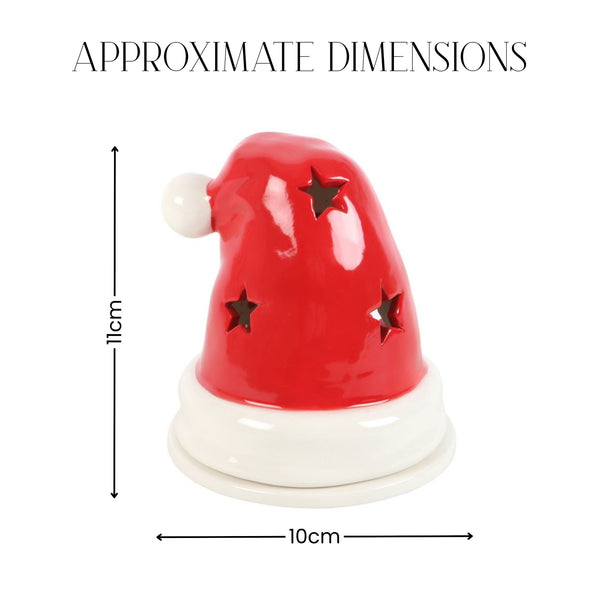 A red and white Santa hat-shaped decorative object with star cutouts, shown with dimension arrows and text reading 'APPROXIMATE DIMENSIONS' indicating 11 cm height and 10 cm width on a white background.