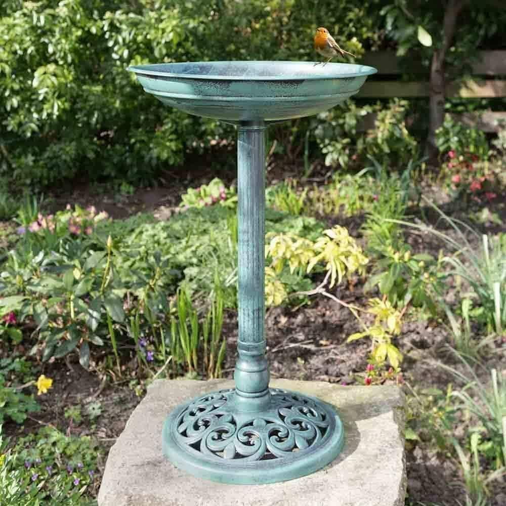 Traditional freestanding bird bath in garden setting