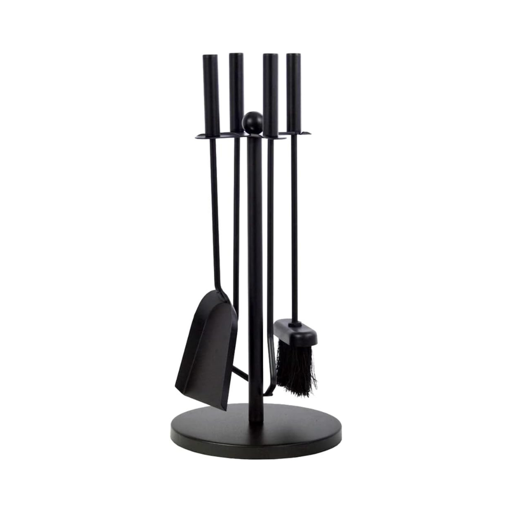 Black fireplace tool set with firewood in front of a lit fireplace.