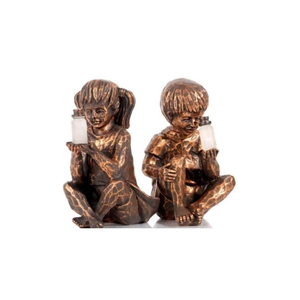 A pair of bronze-finished decorative figurines depicting two children sitting and holding small white candles, set against a plain white background.