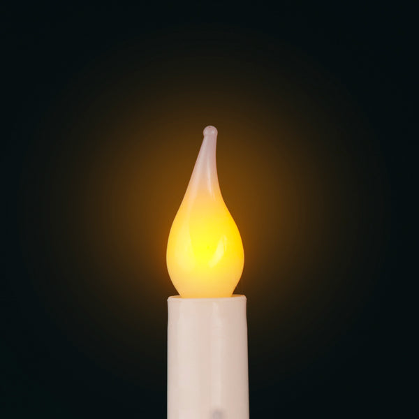 Flickering candle light bulb on a dark background