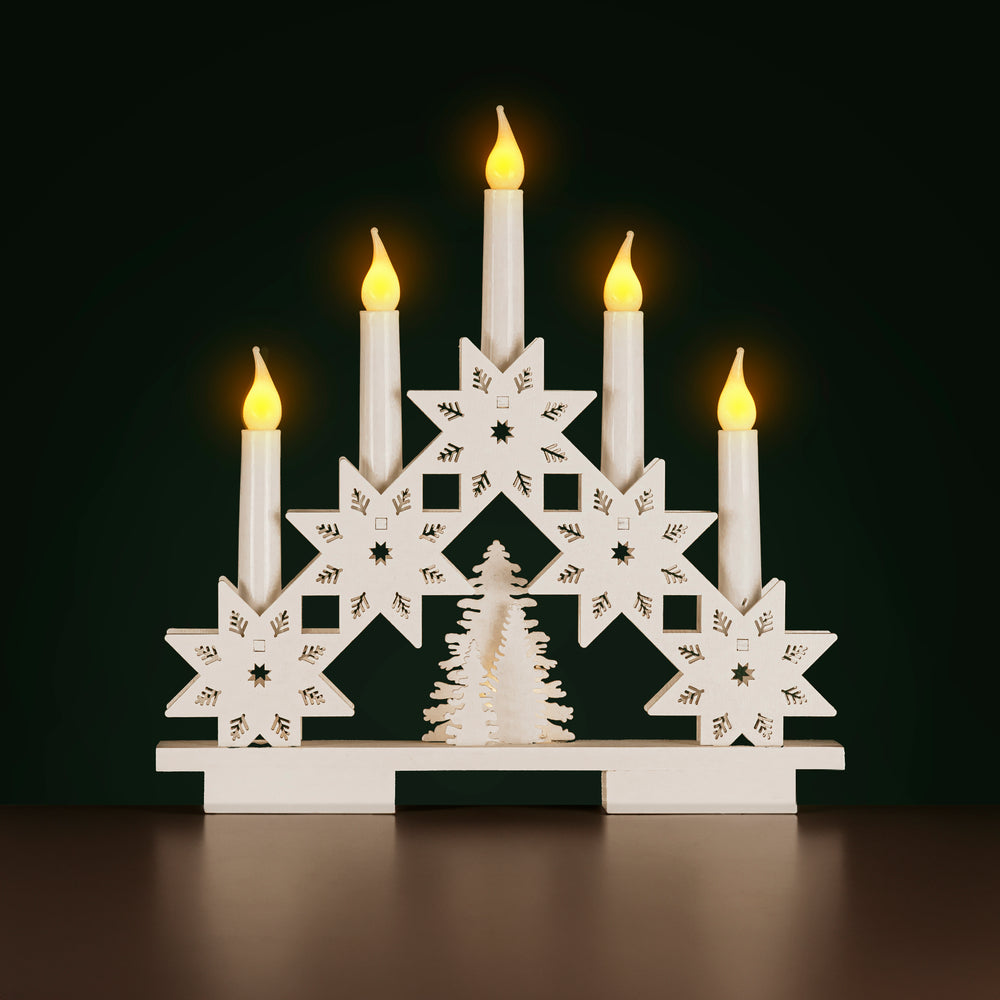 Decorative candle holder with lit candles on a dark background