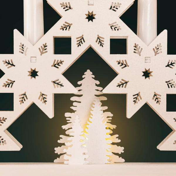 Decorative wall art with geometric patterns and cut-out designs on a black background