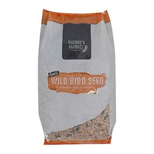 A bag of Nature's Market Wild Bird Seed, featuring a gray paper bag with orange accents and a clear window at the bottom showing the birdseed inside.
