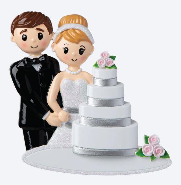 Wedding cake topper with bride and groom figurines on a white background