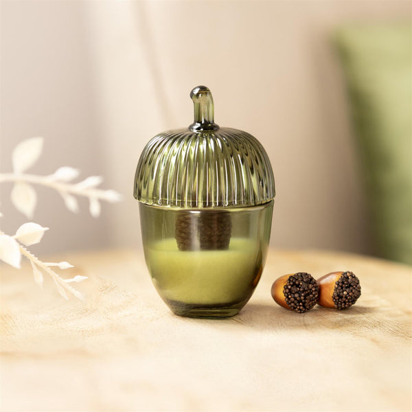 Light green glass candle styled for autumn decorating