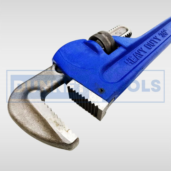 Heat-treated adjustable wrench gripping a metal pipe.