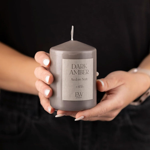 Dark amber fragrance candle for indoor spaces.