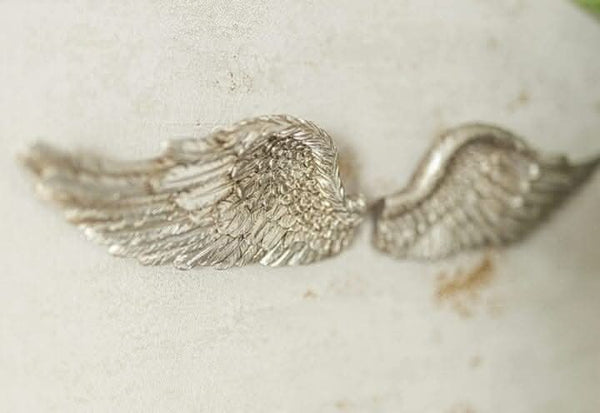 Vintage angel wing ornament displayed in a hallway