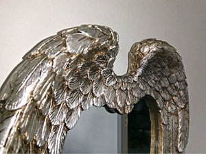 Antiqued silver decorative mirror shown close up