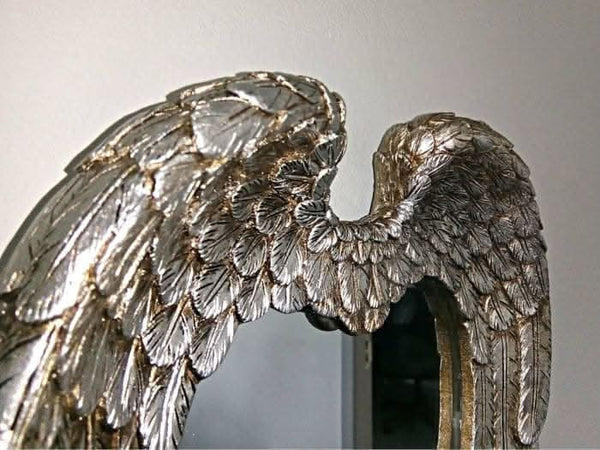 Antiqued silver decorative mirror shown close up