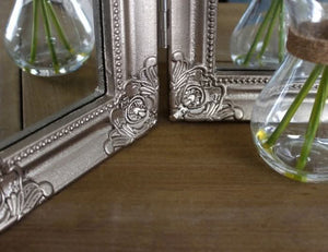 Tri-fold makeup mirror with hinged side panels