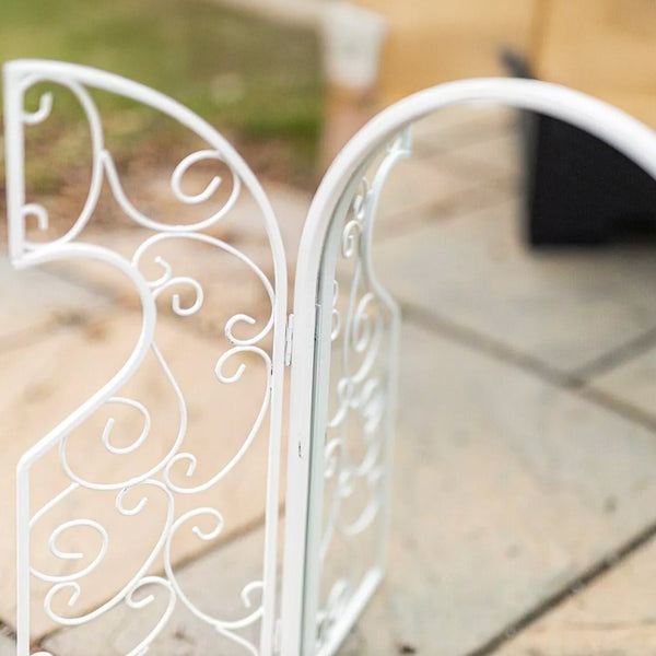 Decorative white mirror creating a wall focal point