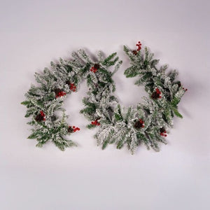 Artificial festive garland decorated with pinecones and berries