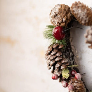 Pinecone heart wreath hanging from natural jute rope