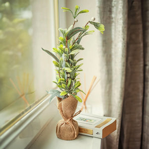 Artificial mistletoe and eucalyptus Christmas tree in jute bag