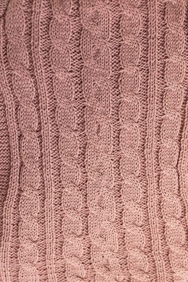 Close-up of a pink knitted fabric with cable pattern