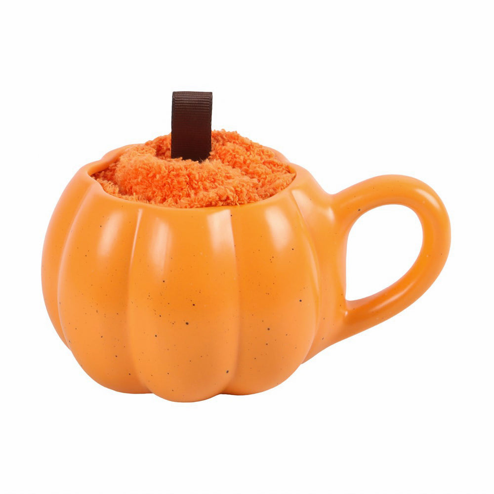 Pumpkin shaped mug with pair of fluffy autumn socks