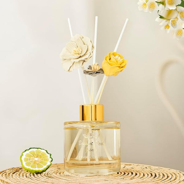 Reed diffuser with floral elements on a neutral background