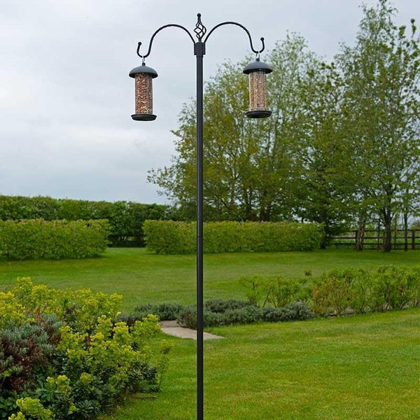 Outdoor bird feeding stand installed in lawn