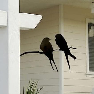 Black bird silhouette displayed on wooden fence