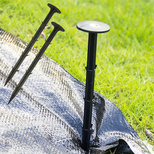Black ground pegs used around a flower bed