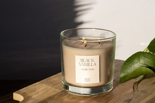Three wick vanilla candle displayed in a cosy living room