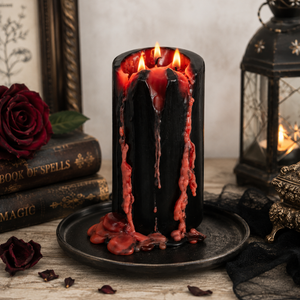 Large spooky pillar candle styled as a gothic centrepiece