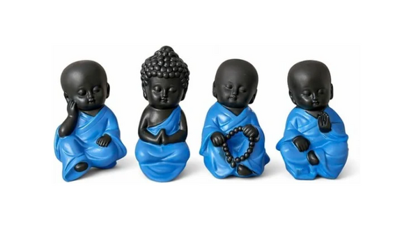 Four Buddha statues displayed together in different poses