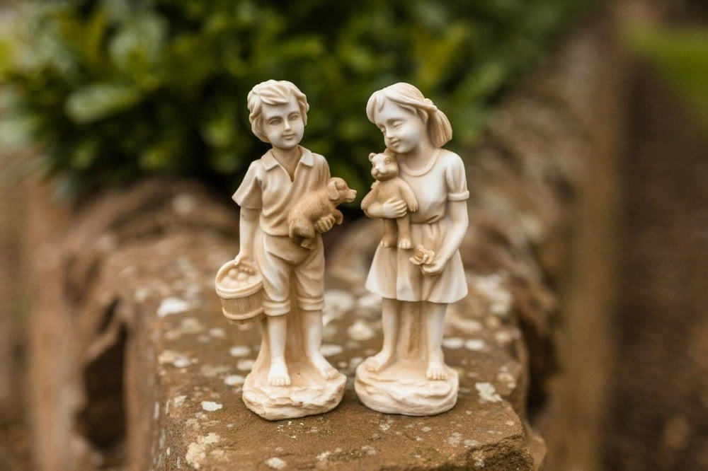 Standing boy and girl garden statues set