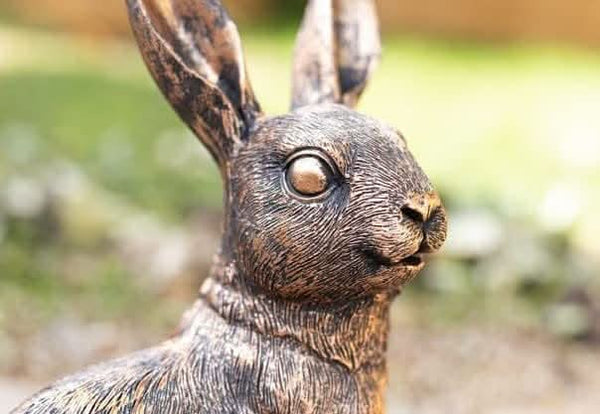 Bronze rabbit family garden ornaments displayed together