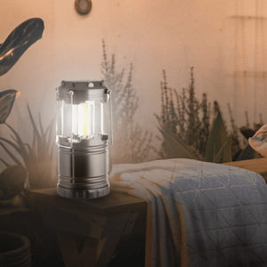 Portable LED lantern shown hanging by handles