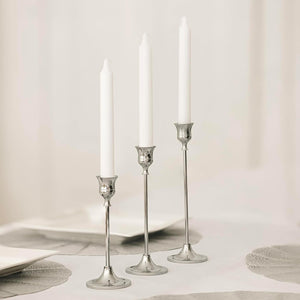 Silver candlesticks with unscented white taper candles